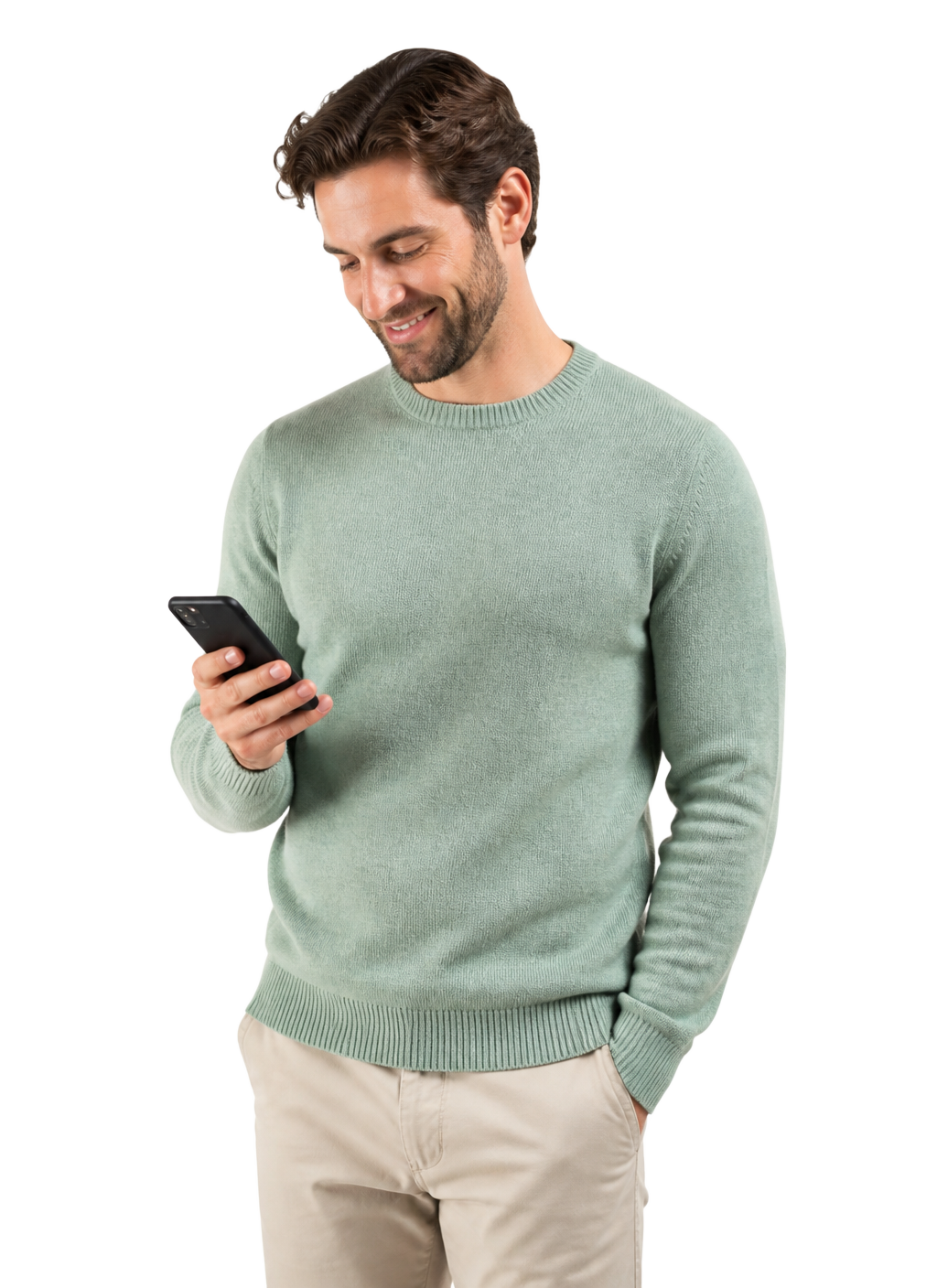 A man in a sea-green jumper reading a message on his phone