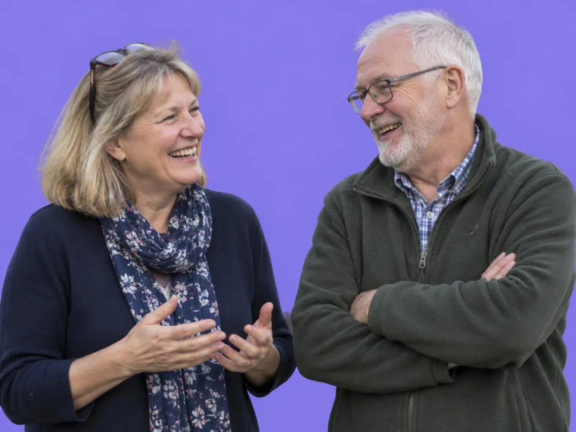 A community group organiser laughing with a volunteer.